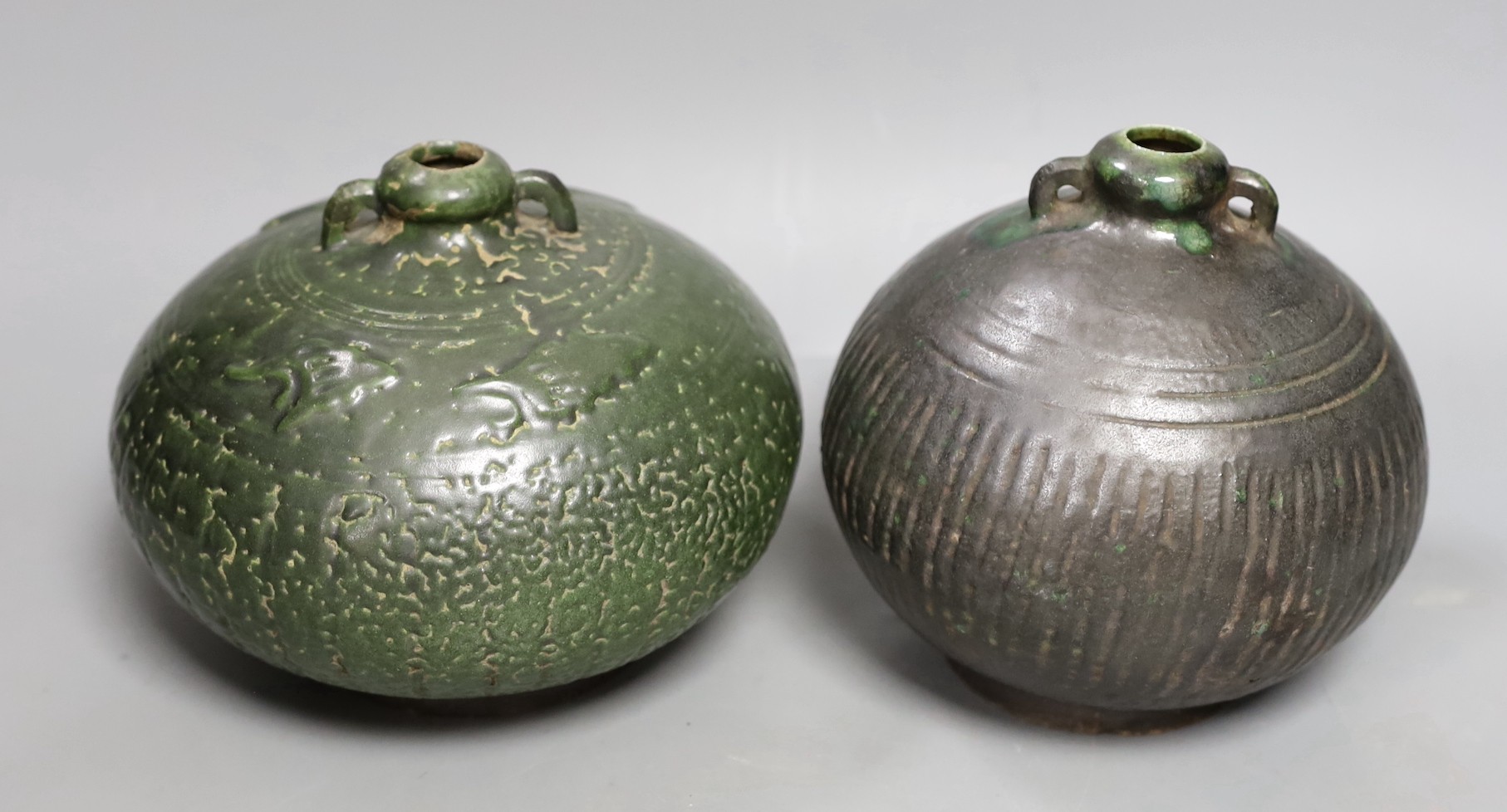 Two Thai Sawankhalok green-glazed ring handled jars, 15th-16th century, tallest 15.5cm